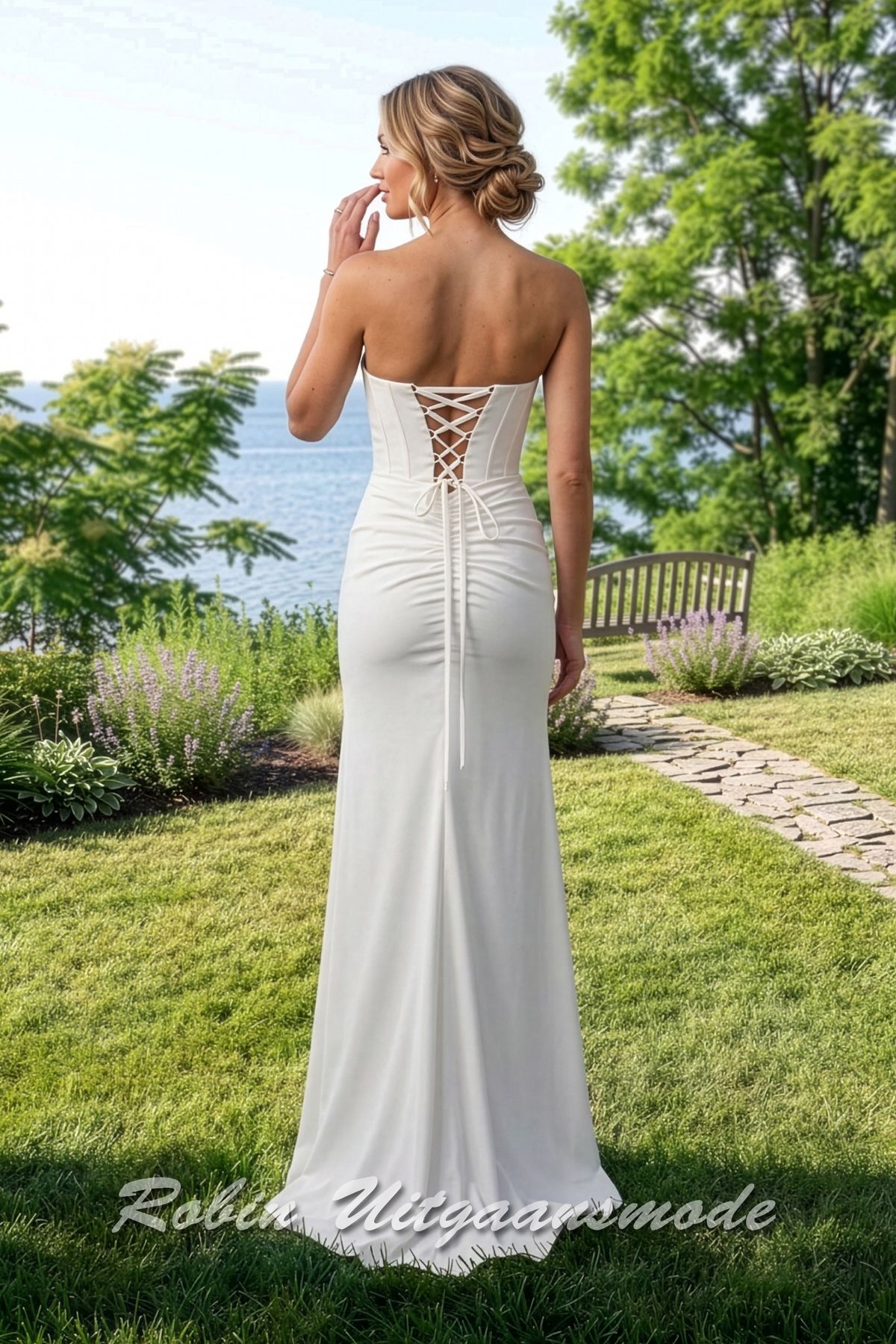 Achterkant van de Strapless trouwjurk met strak geplooid lijfje, een heartshape buste afgewerkt met kleine kralen en hoge split